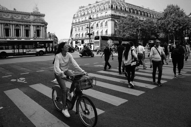 a woman rides her bike in the street