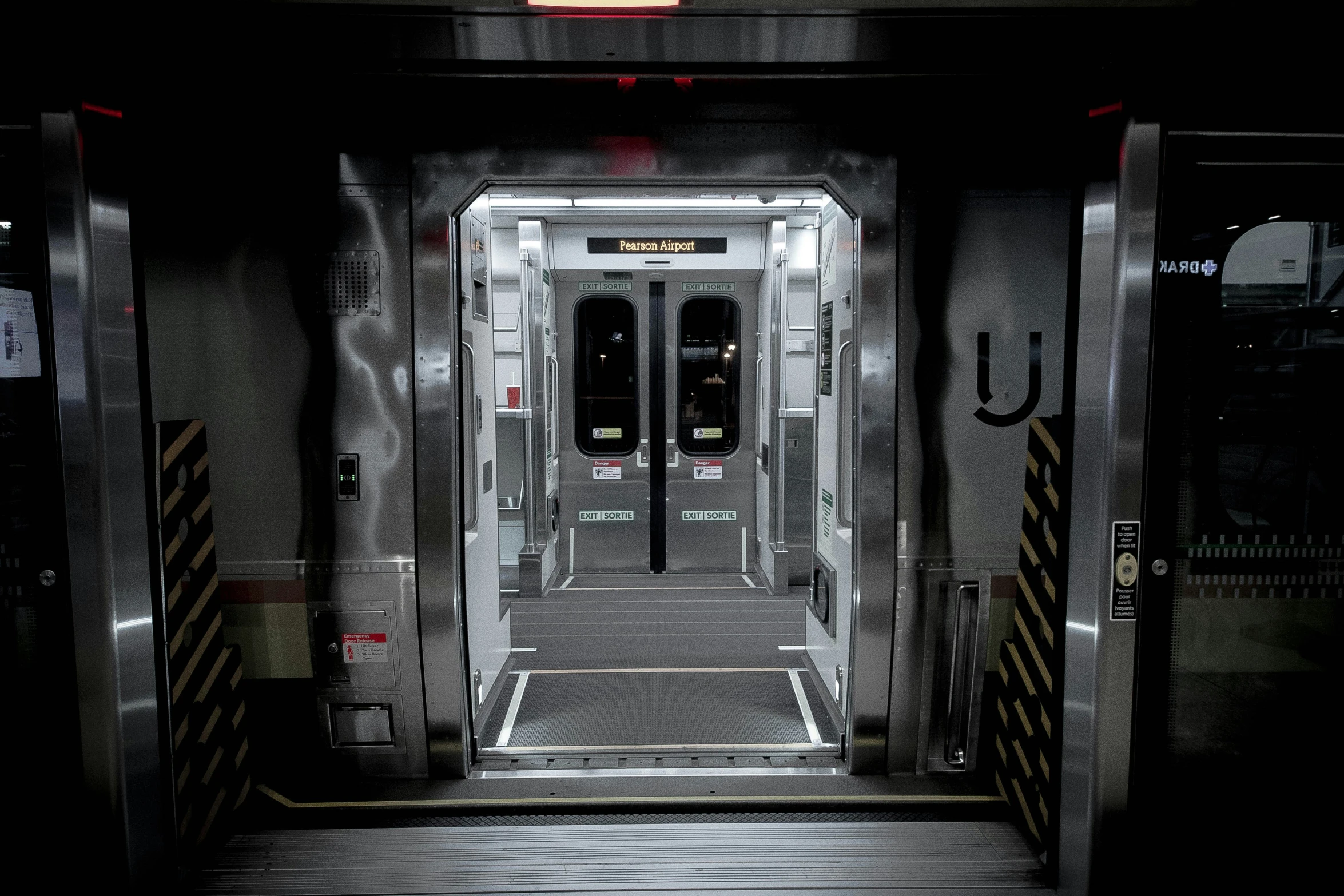 a tall metal elevator sitting inside of a room