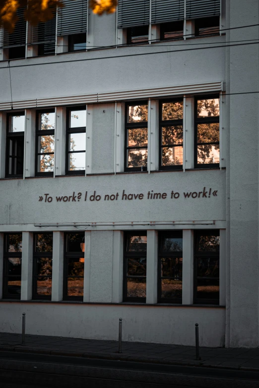 an art decolorated facade with open windows, with words written in black