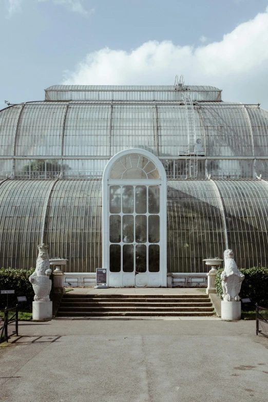 a greenhouse sitting on top of a concrete platform