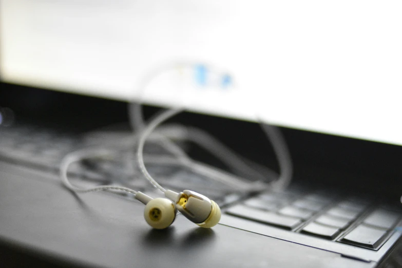 close up of headphones plugged into a laptop computer