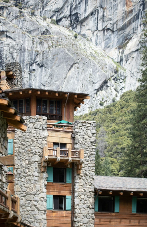 a rock building that has a bunch of wood windows