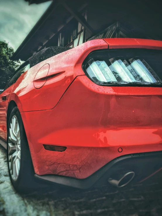 a red car that is parked outside a house