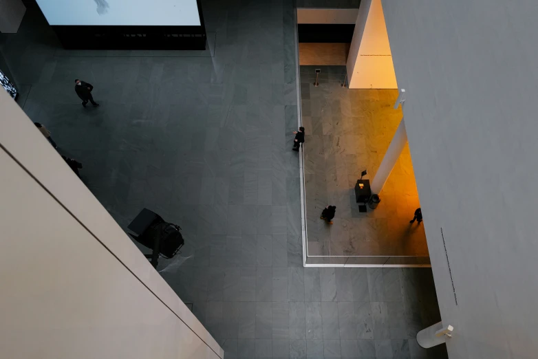 people sitting at tables in a large, empty room