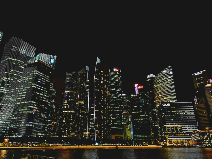 very bright city buildings and water at night