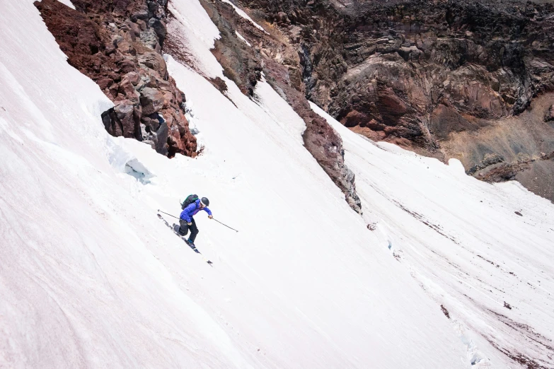 the person is coming down the snowy hill on skis