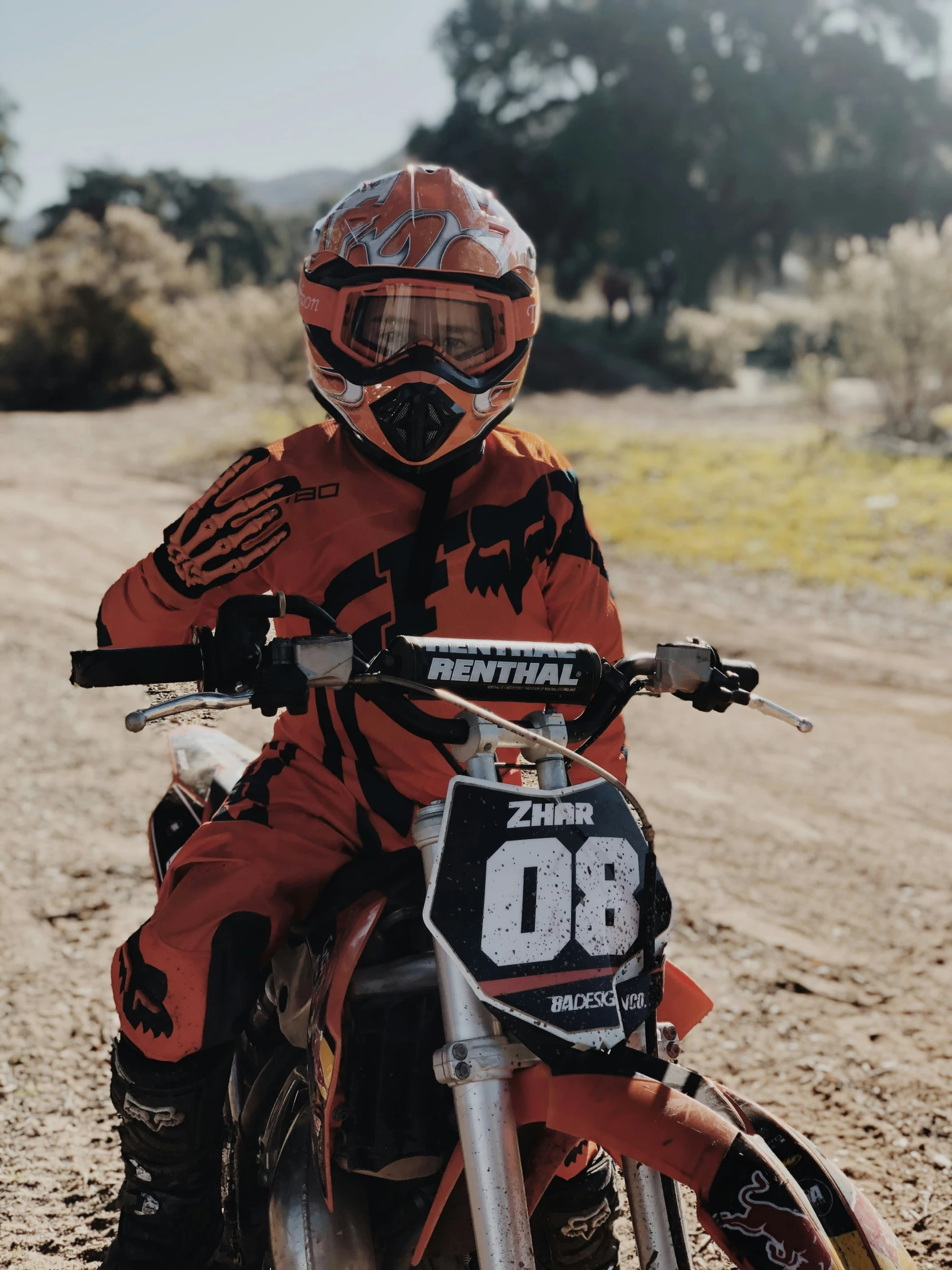 a boy on a dirt bike in the dirt