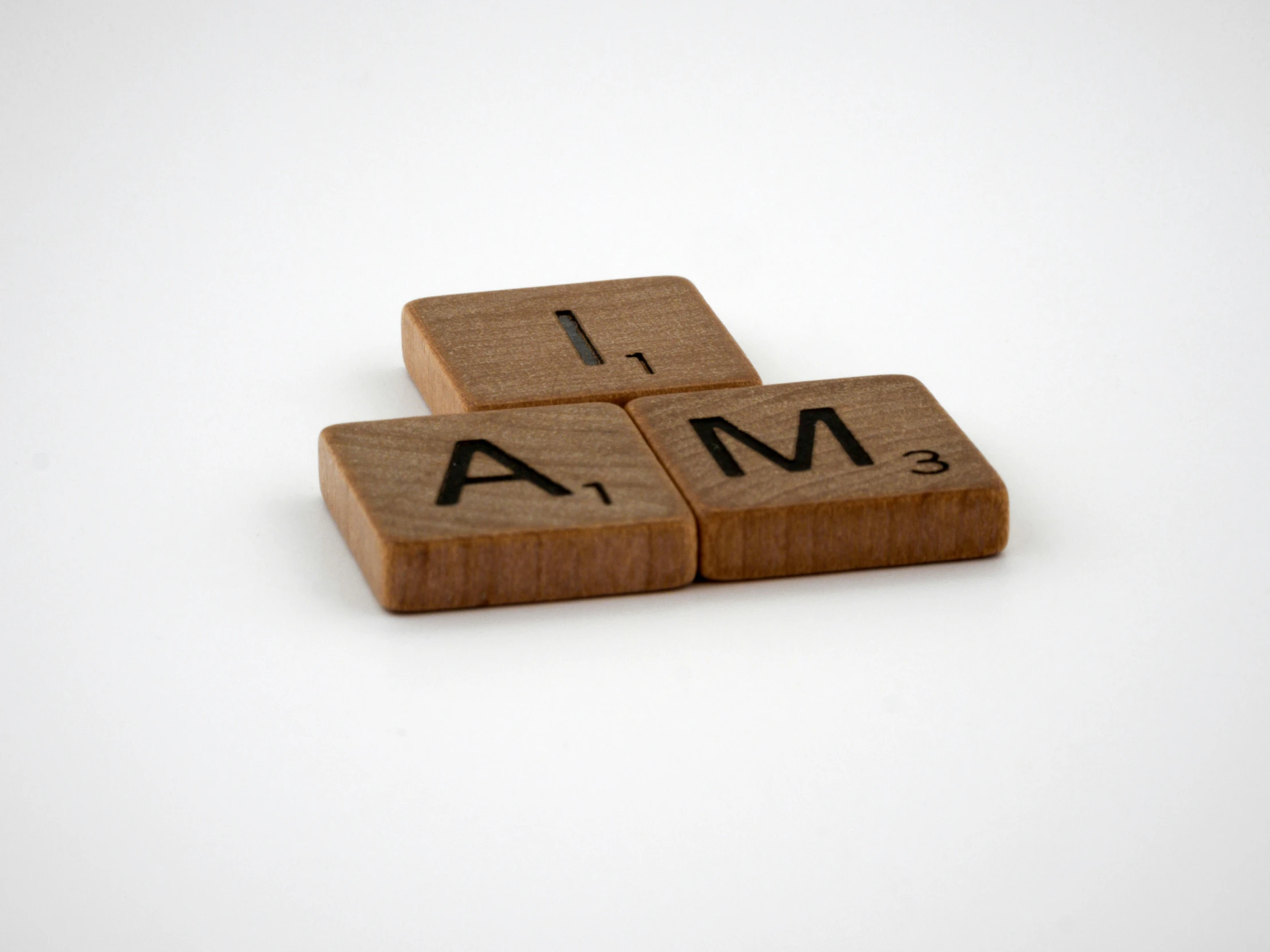 a piece of scrabble wood that has the words team and i am written on it
