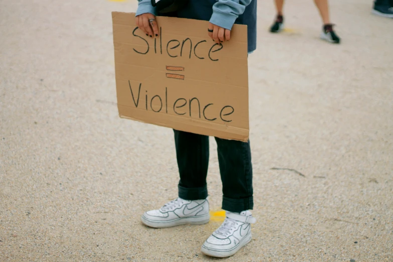 person holding a sign reading, science and violence