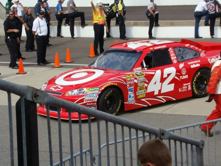 a red car with white and yellow paint and stickers