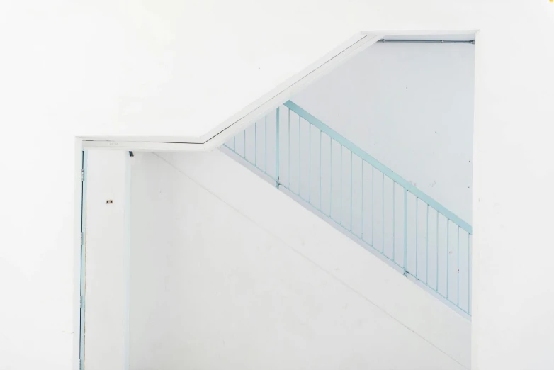 a white wall with a door and some stairs