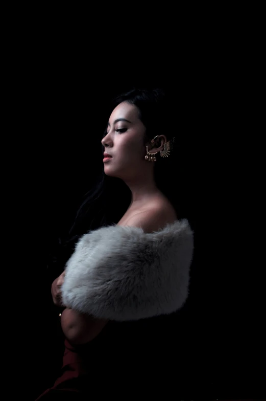 a woman wearing an elegant white fur stole over her shoulder