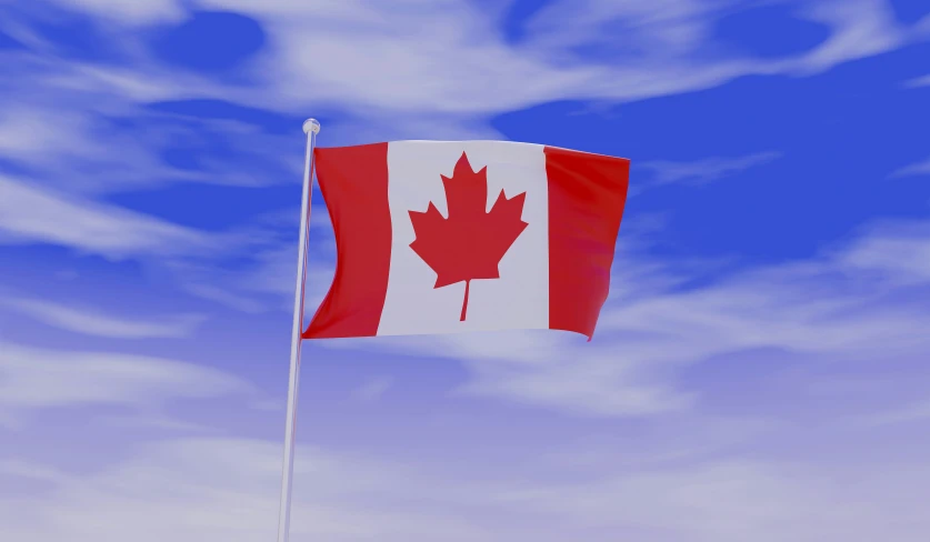 a canadian flag is flying against a beautiful blue sky