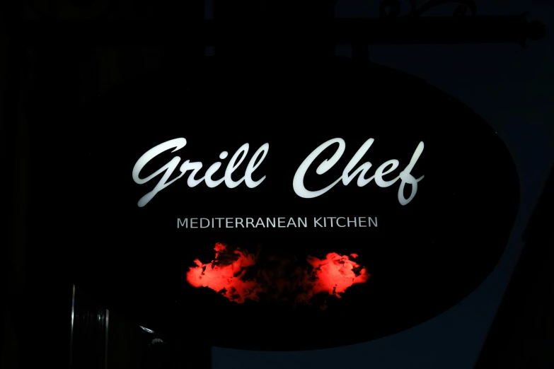 a black sign reads grill chef mediterranean kitchen