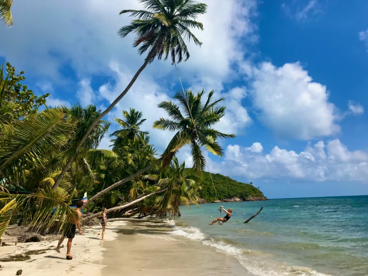 two people are in the water next to a beach