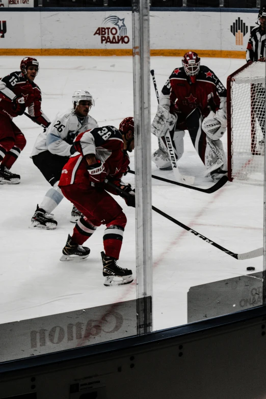a hockey game in progress, through the glass