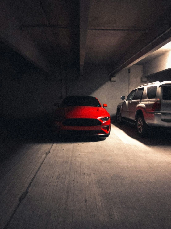 two cars that are driving in a garage