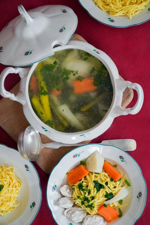 soup and vegetables are set on white plates