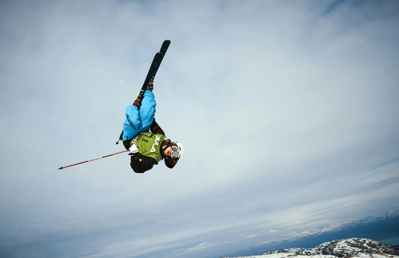 a skier is in mid air in front of mountains