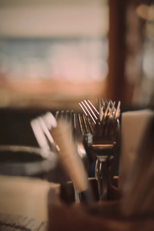 there are several silver forks in the holder