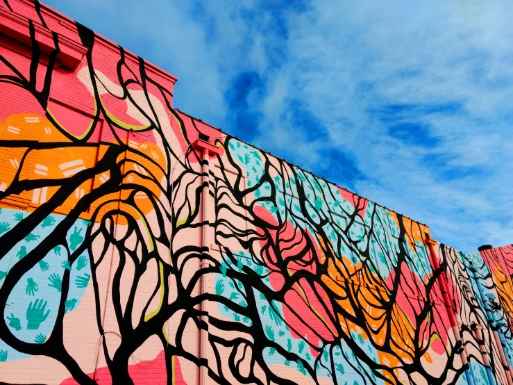 several colorful murals on the side of a building