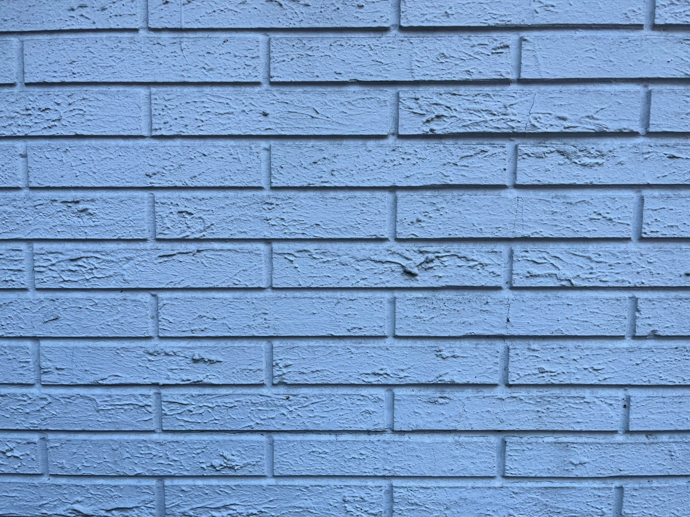 a closeup view of a light blue brick wall