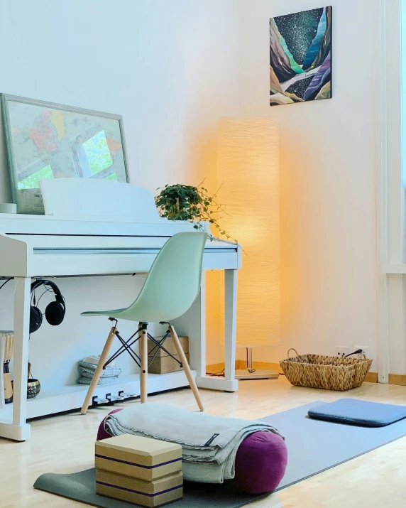 a living room with white furniture and a piano