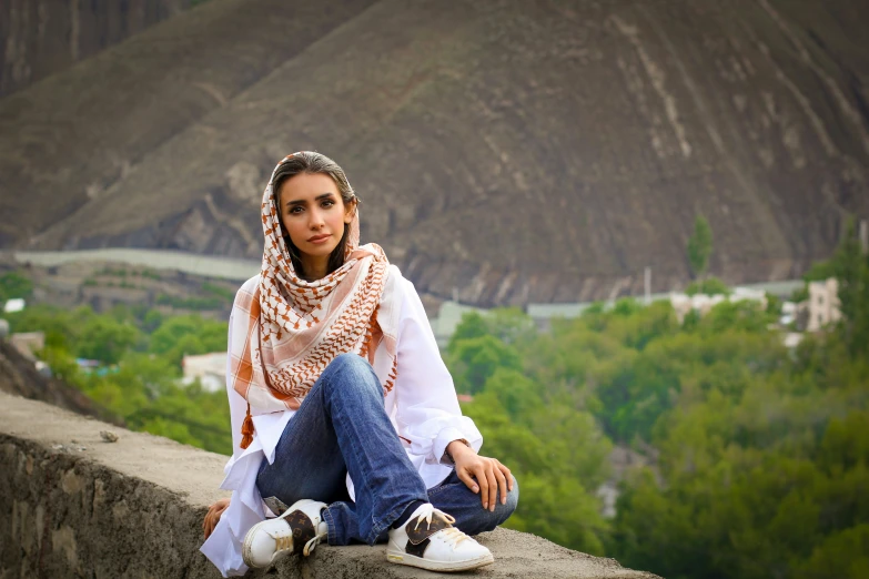 a woman sitting on top of a wall