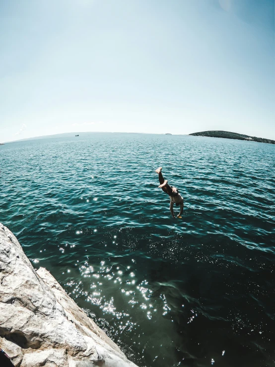 the person is doing tricks in the water