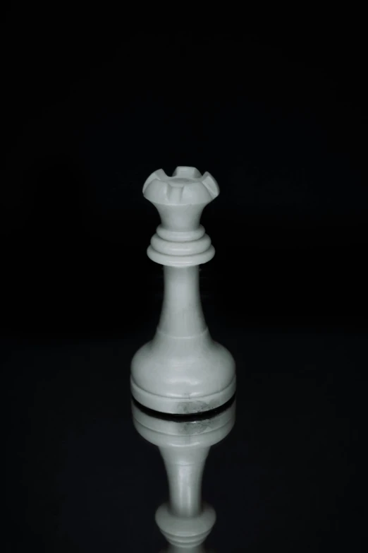 a white object sitting on top of a reflective surface