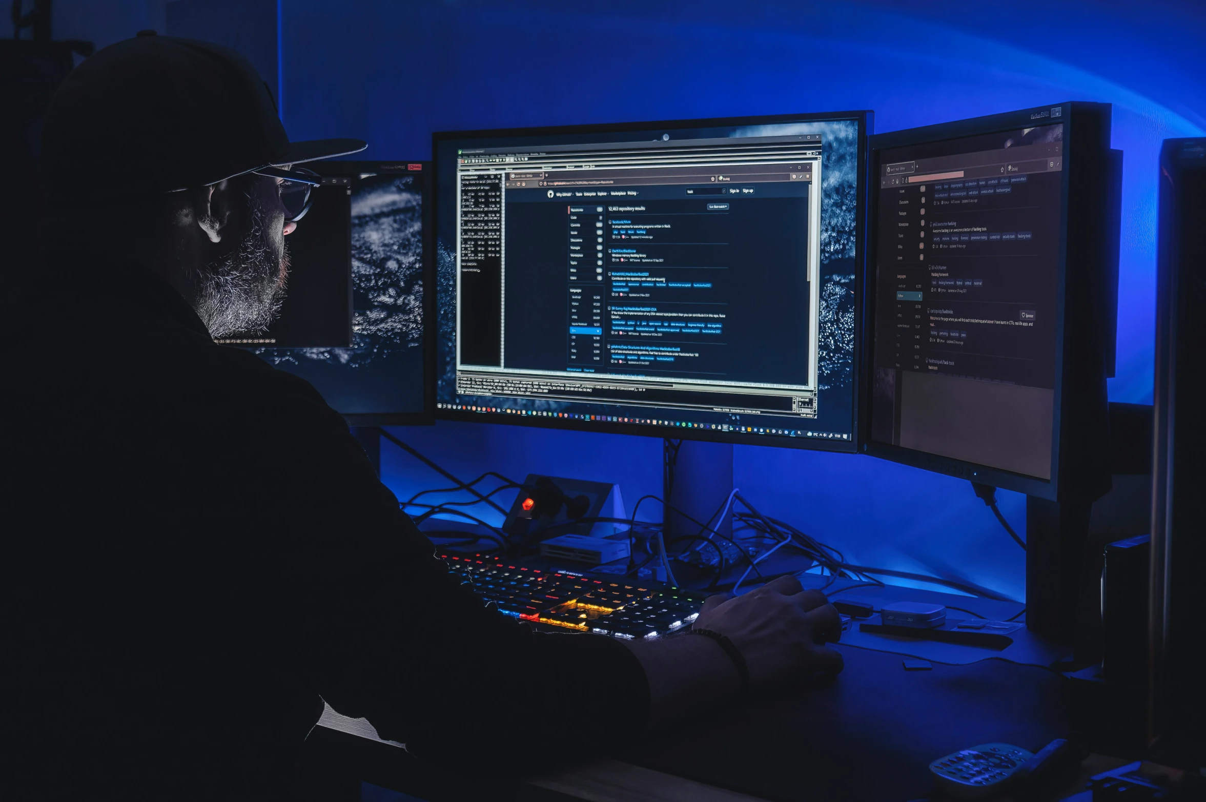 man using a computer with multiple screens in front of him