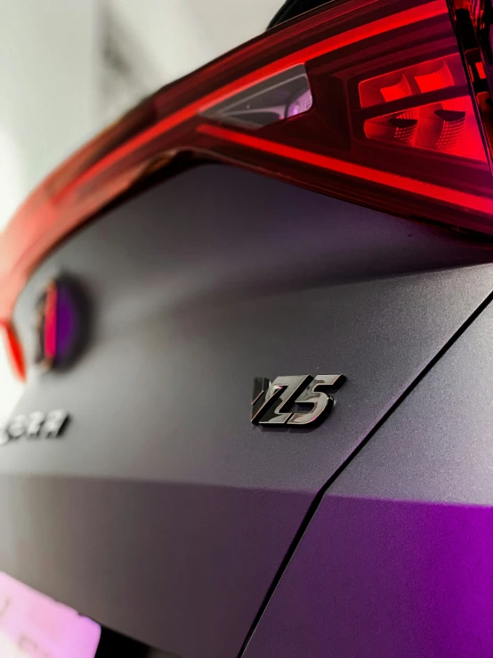 a purple car tail light with the letter s on it