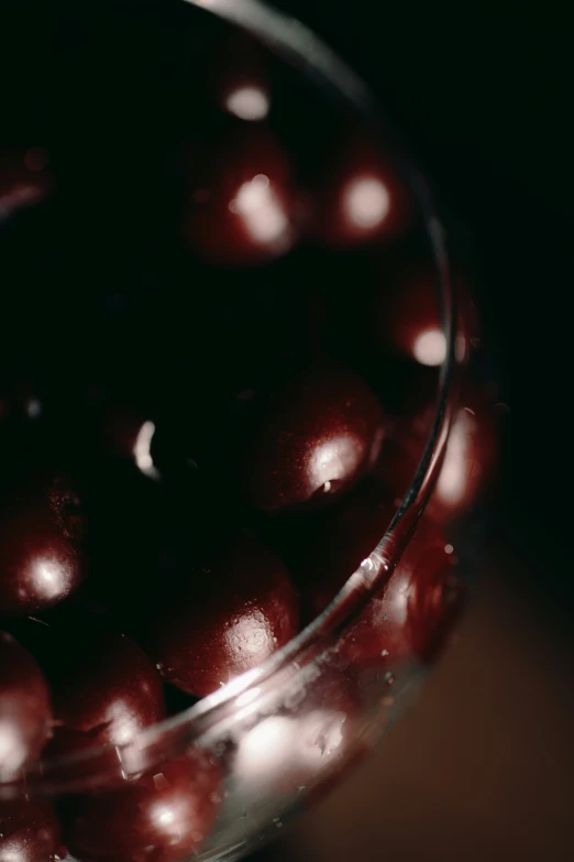 a clear glass filled with red fruit