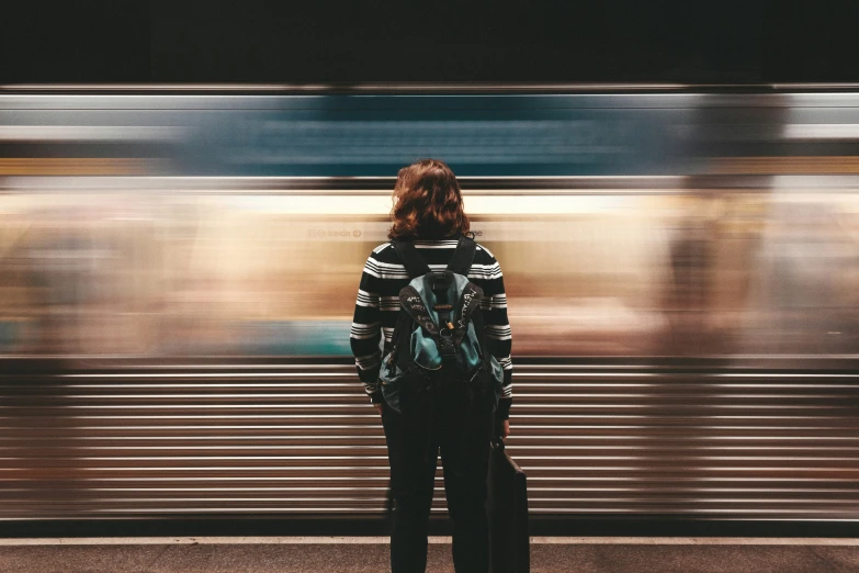 the person is waiting at the train station