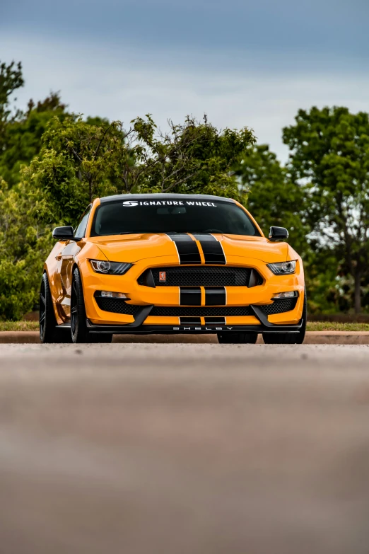 a yellow sports car with its front lights up