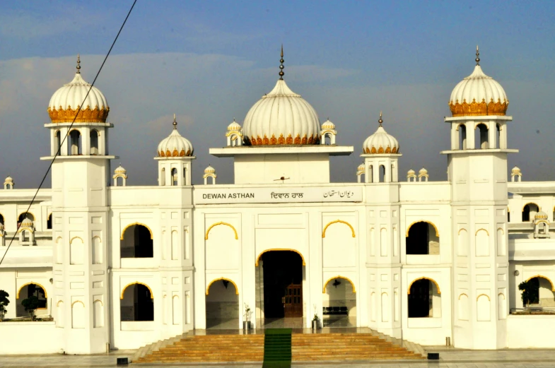 a very big white building with several domes