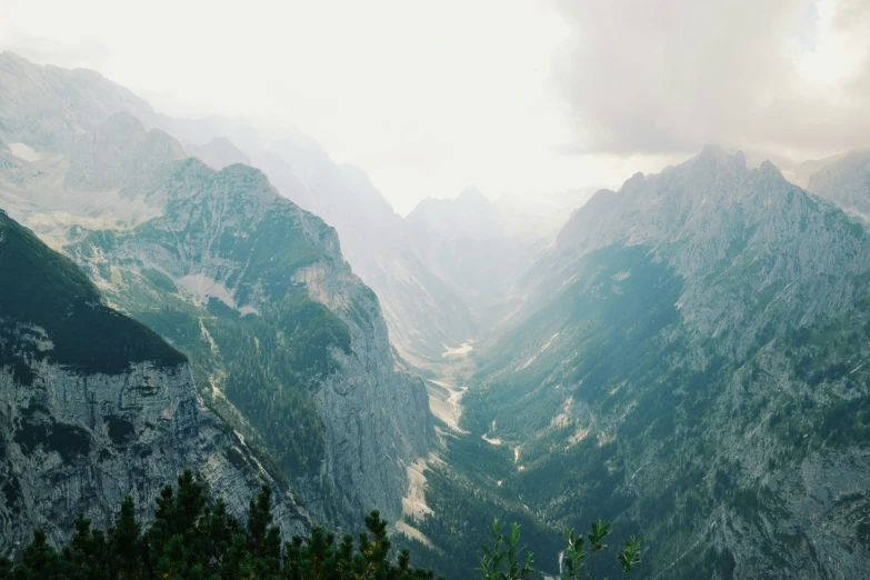 view of mountains, looking down on trees in the foreground