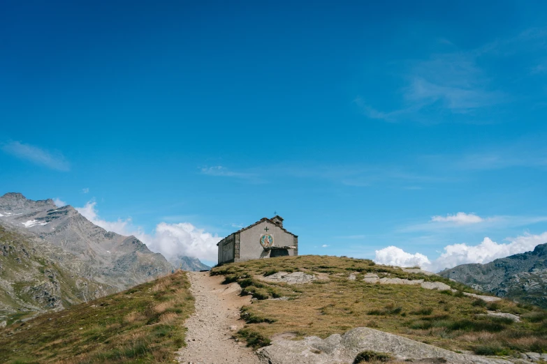 a mountain with a house on top in the distance