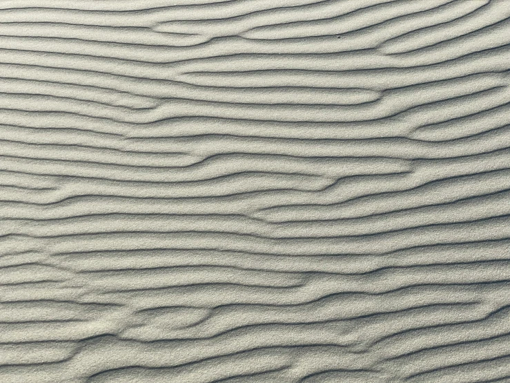 sand that is wavy in the middle of a beach