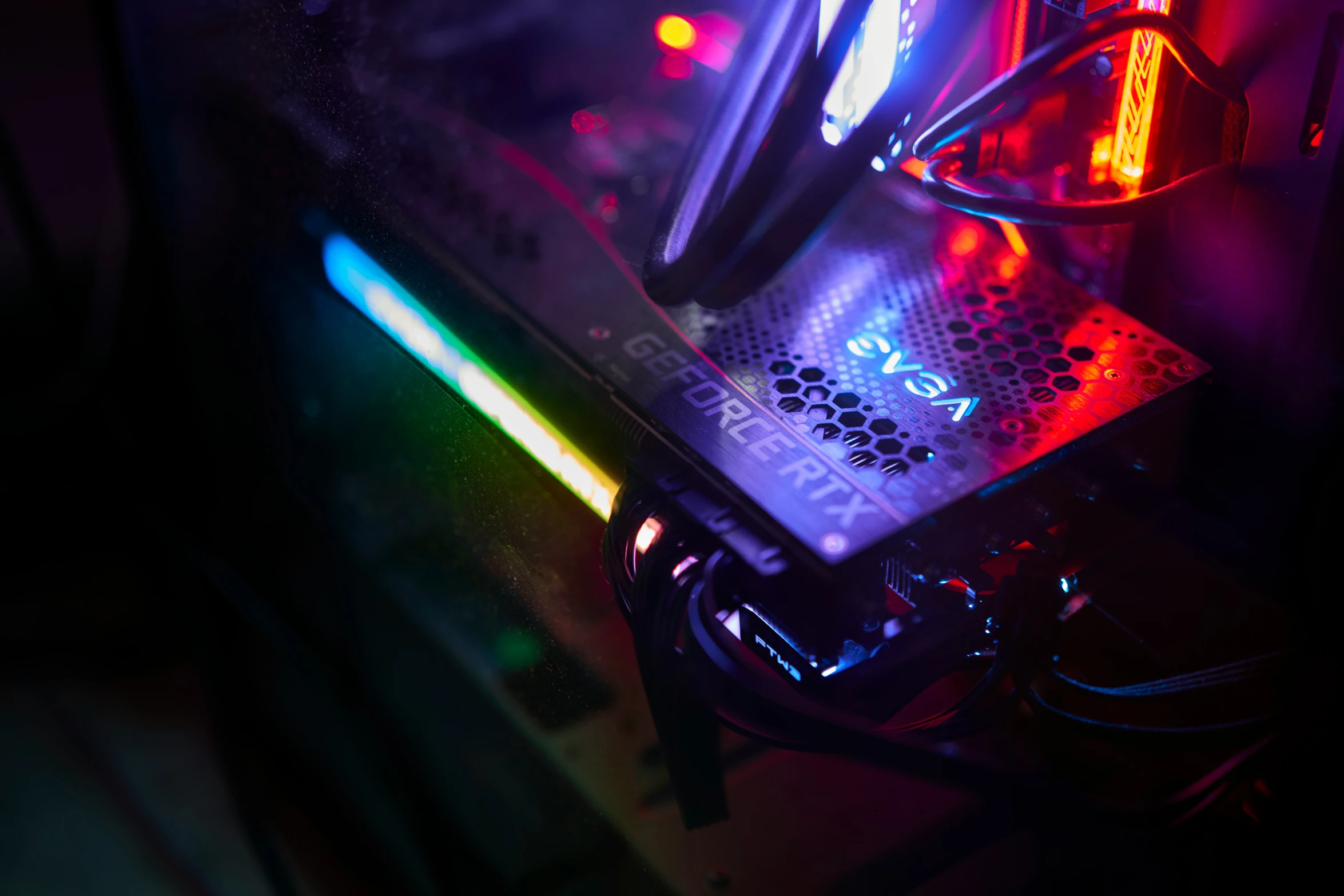 a close up of a computer case with colored light coming from the front