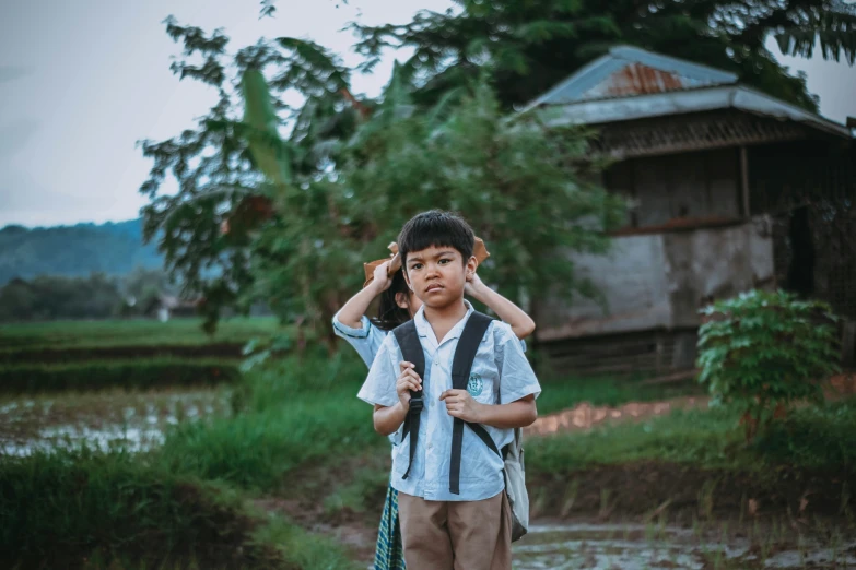 a  walking through the countryside while holding a backpack