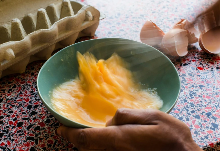 a person is mixing soing into a bowl