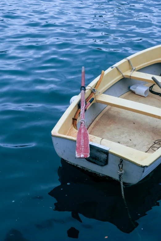 a small white boat floating in the ocean