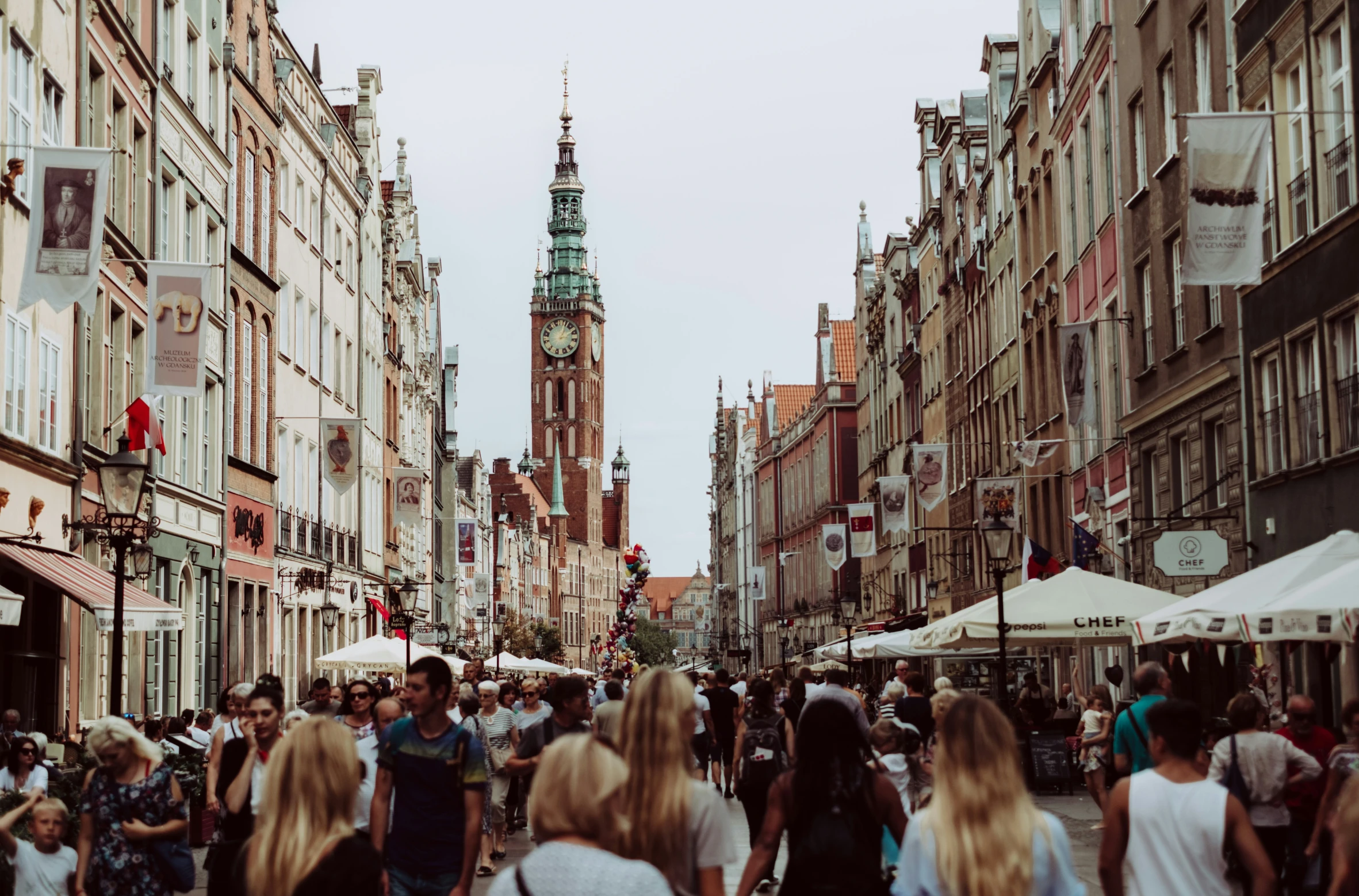 a lot of people walking around in a city street