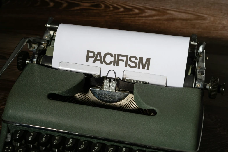 an old typewriter with a piece of paper that reads pacifism