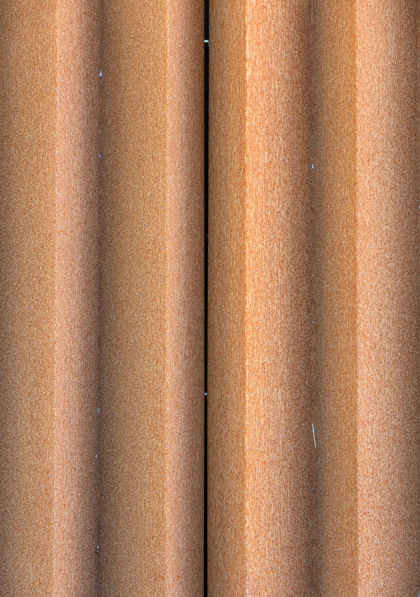 a room with a brown texture curtain and a white floor