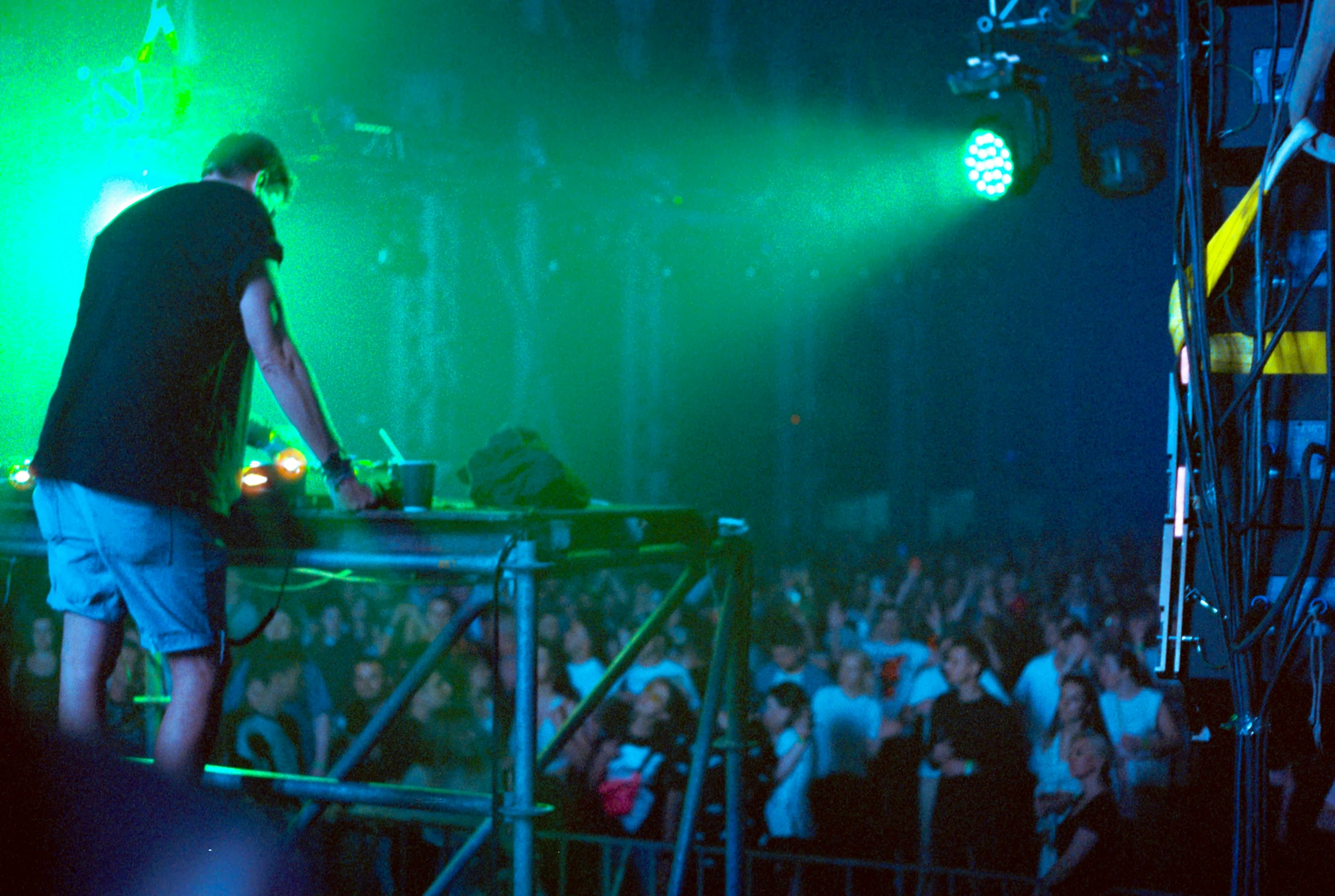 a man standing on top of a stage next to an audience