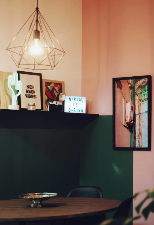 a room with a small round table surrounded by various art