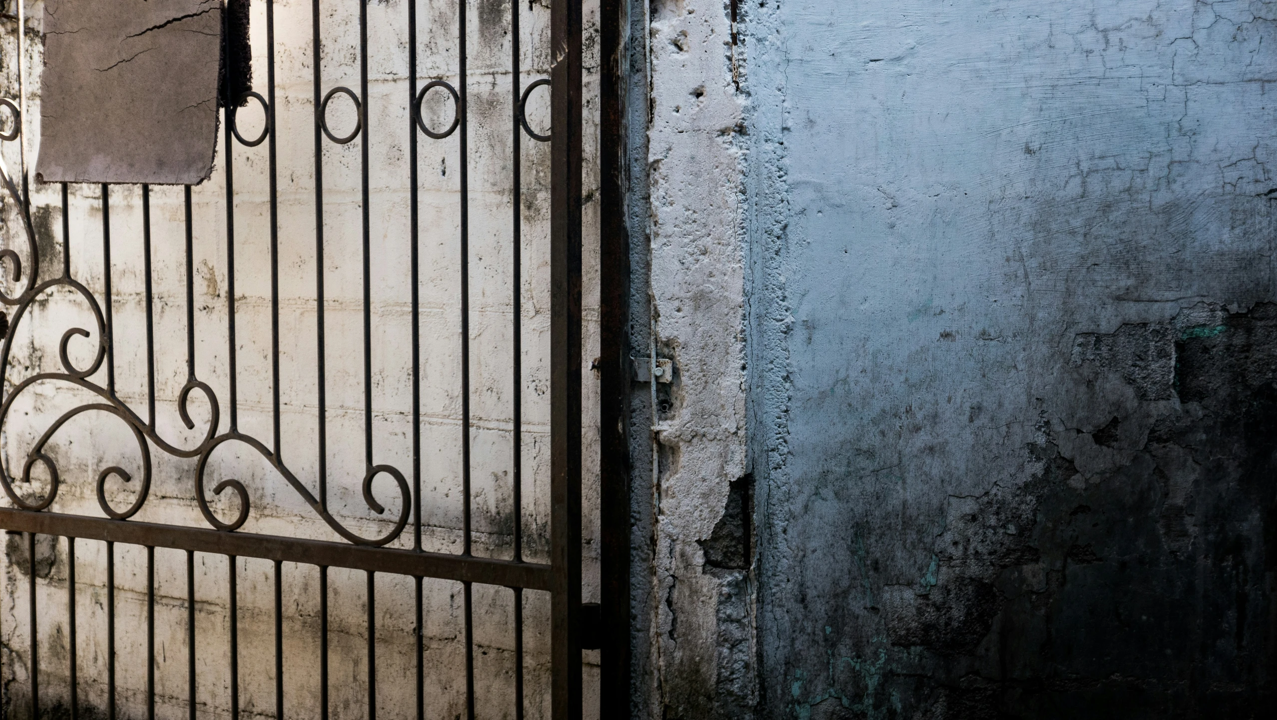 a fence is on a blue wall with a door