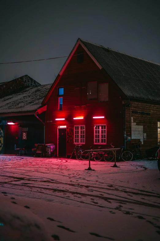 a large red house with three lights on it